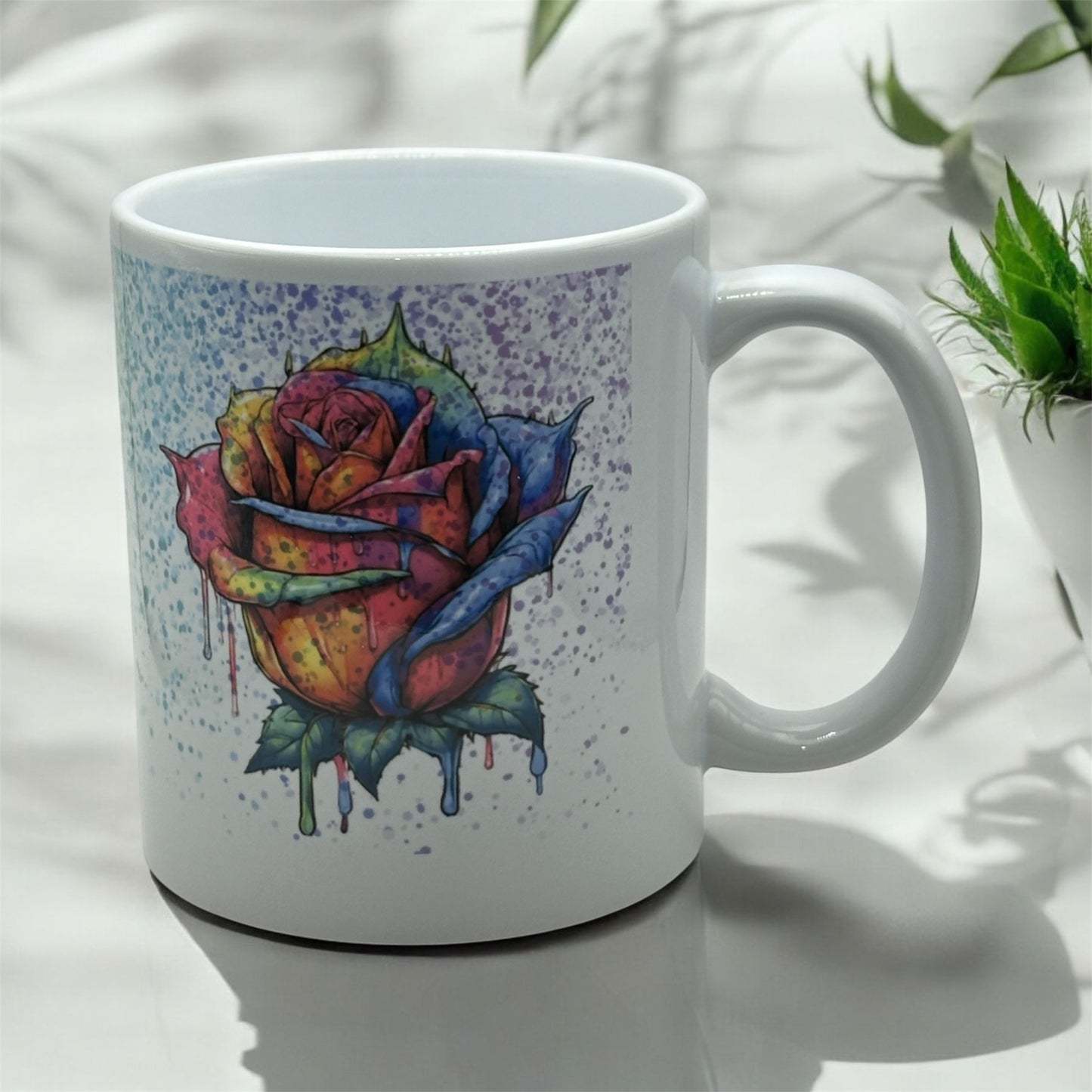 11 ounce white sublimated mug with Rainbow splatter on Rainbow dripping rose