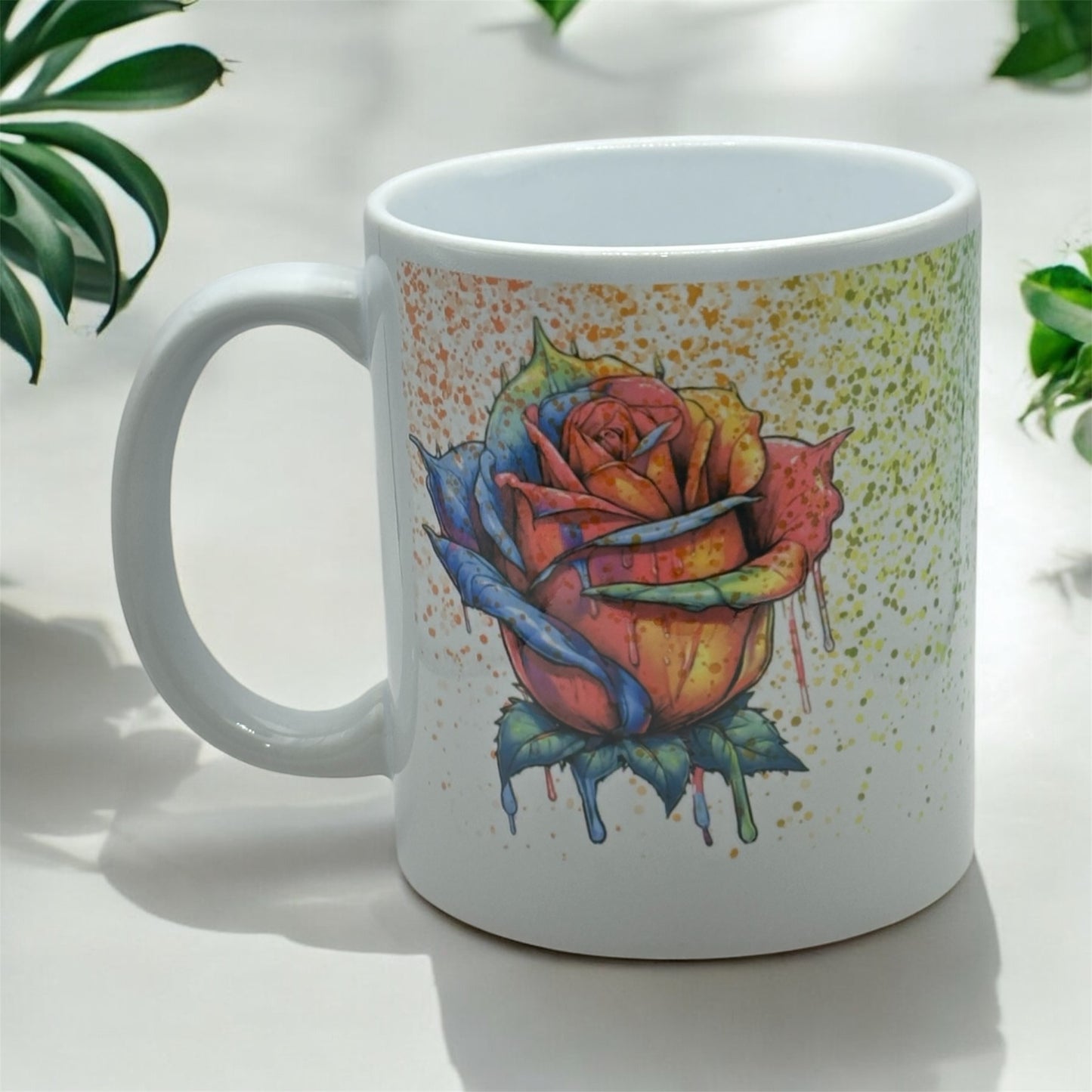 11 ounce white sublimated mug with Rainbow splatter on Rainbow dripping rose