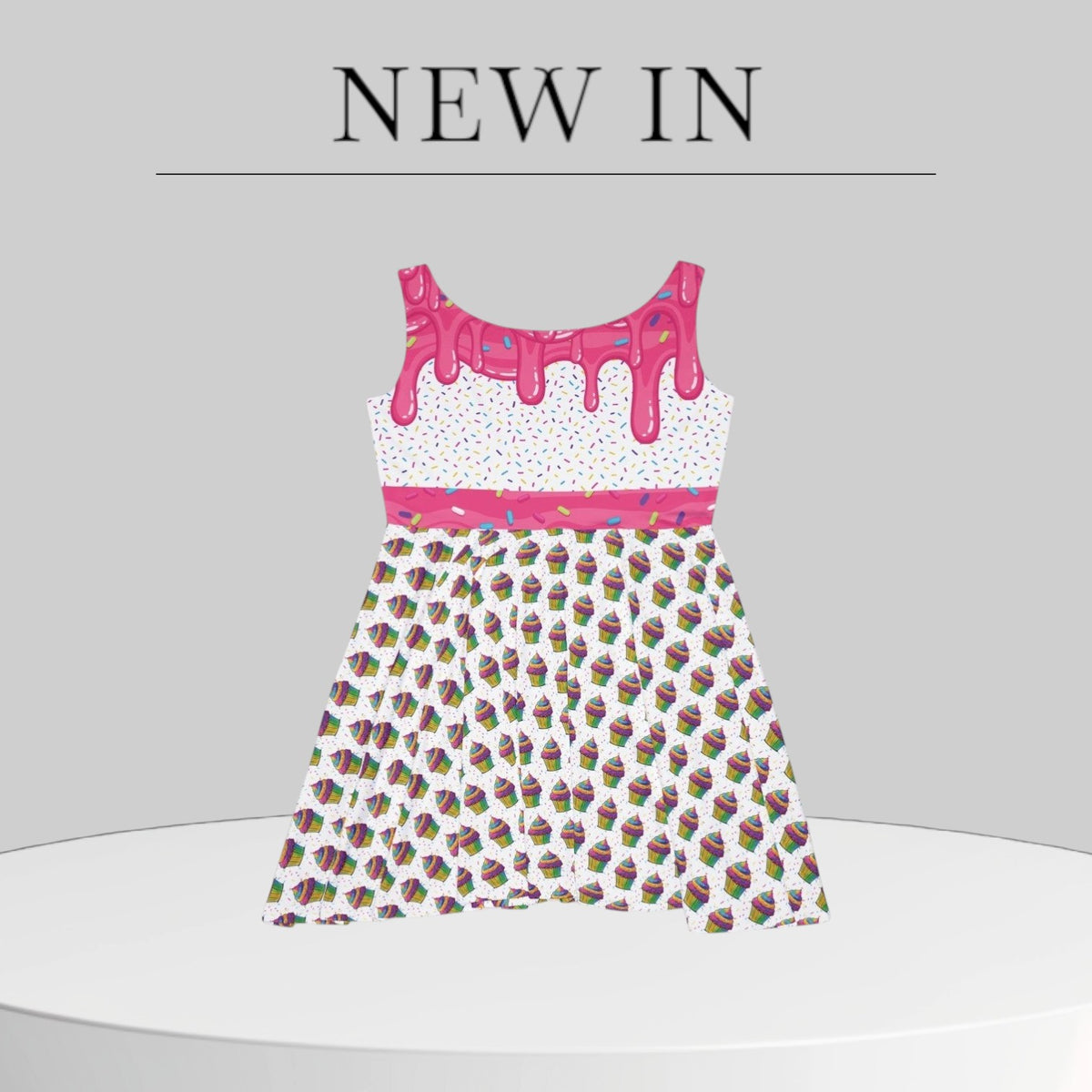 Jamrozy's Limited Company skater dress with pink icing drip top and colorful cupcake pattern on a white background