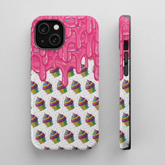 A phone case shown from the back and side on a plain white background. The case has a white base with a repeating pattern of colorful rainbow cupcakes and pink dripping icing on the top half.
