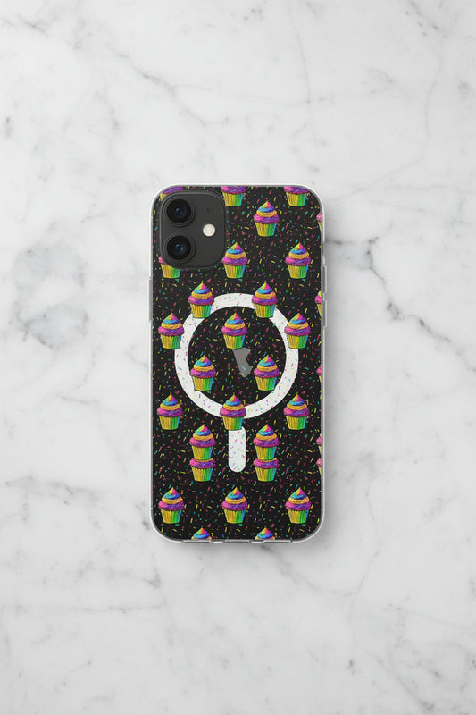 A clear phone case with a printed design featuring a dark gray background, colorful rainbow cupcakes, sprinkles, and a large white magnifying glass graphic.
