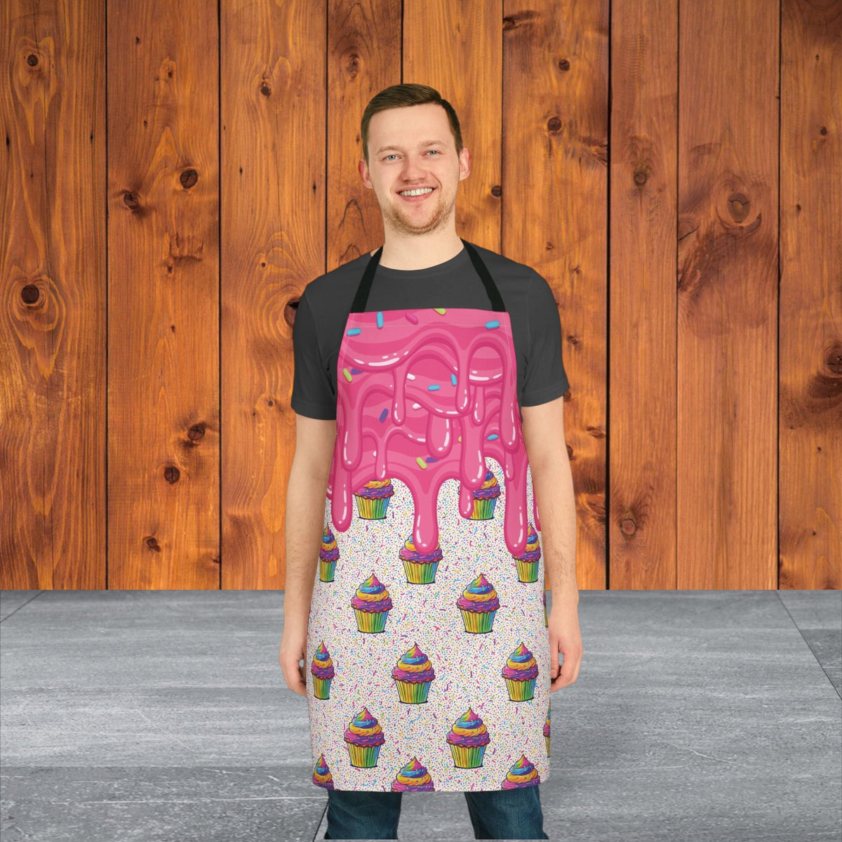 Jamrozy's Limited Company polyester canvas apron featuring a pink cupcake frosting print with black tie-back straps.