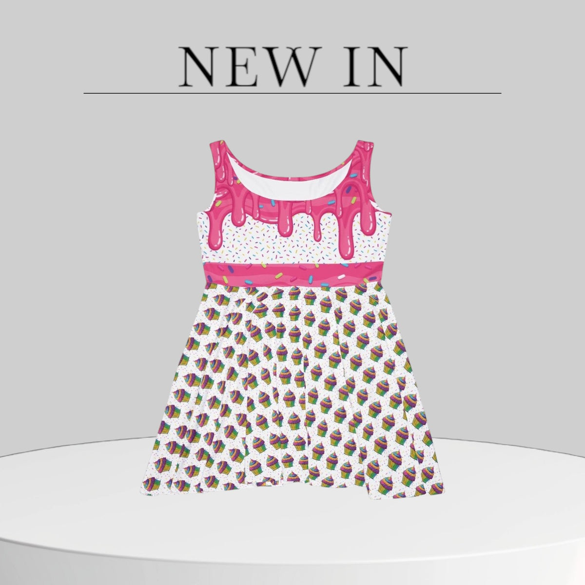 Jamrozy's Limited Company skater dress featuring a pink icing drip top and a colorful cupcake all-over print pattern.