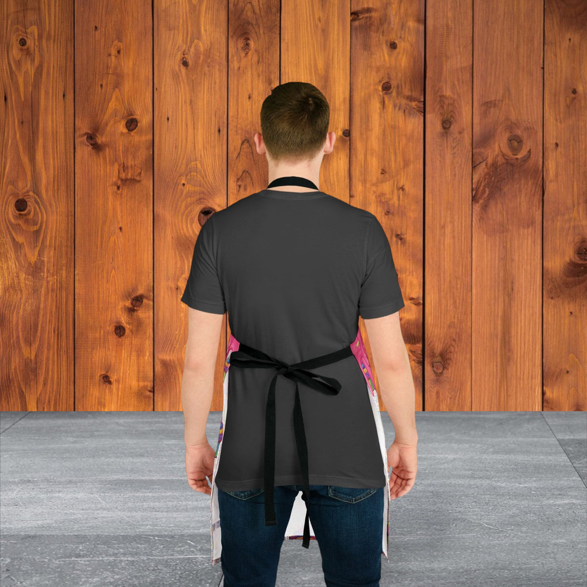 Jamrozy's Limited Company polyester canvas apron with black tie-back straps worn by a man against a wood background.